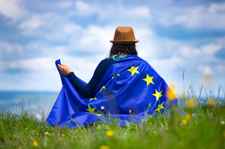 Woman sitting in field with EU flag